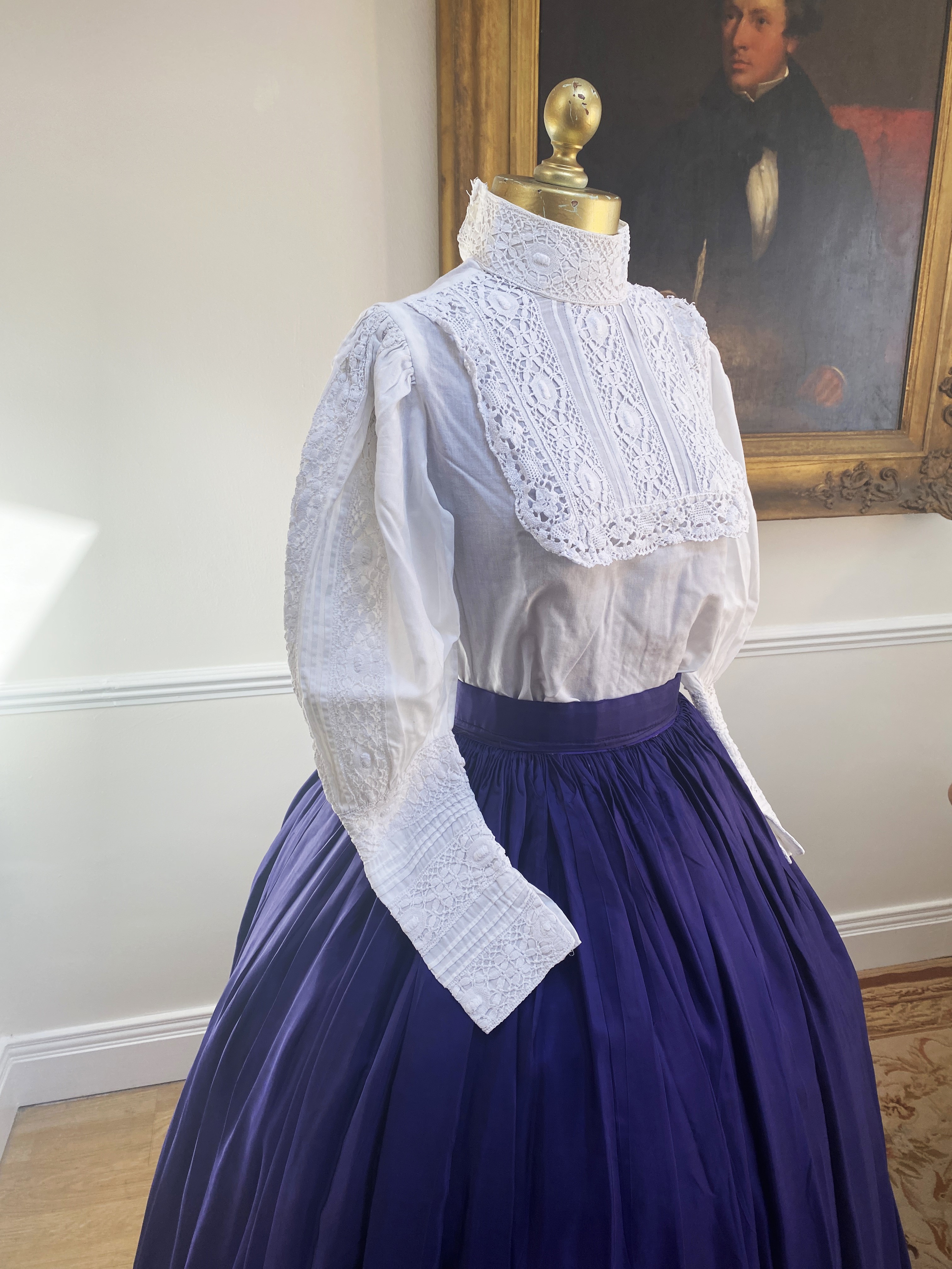 A Victorian style full skirt in peacock blue taffeta with white blouse and lace trim. Size Small/Medium.